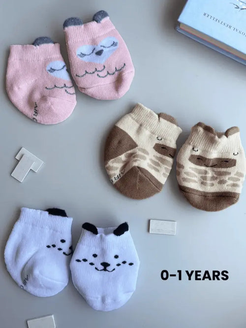 Air Garb baby combo socks for infants 0-1 years; a 6-pair collection arranged in a circle featuring animal faces like pink owl, brown giraffe, and white dog, alongside kitten-themed socks in purple, lime green, and blue.